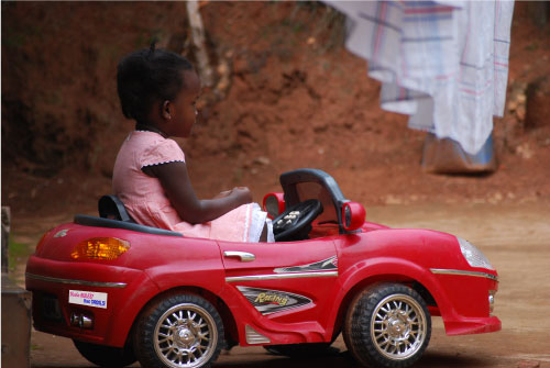 Barbie bumper sticker on red kid car